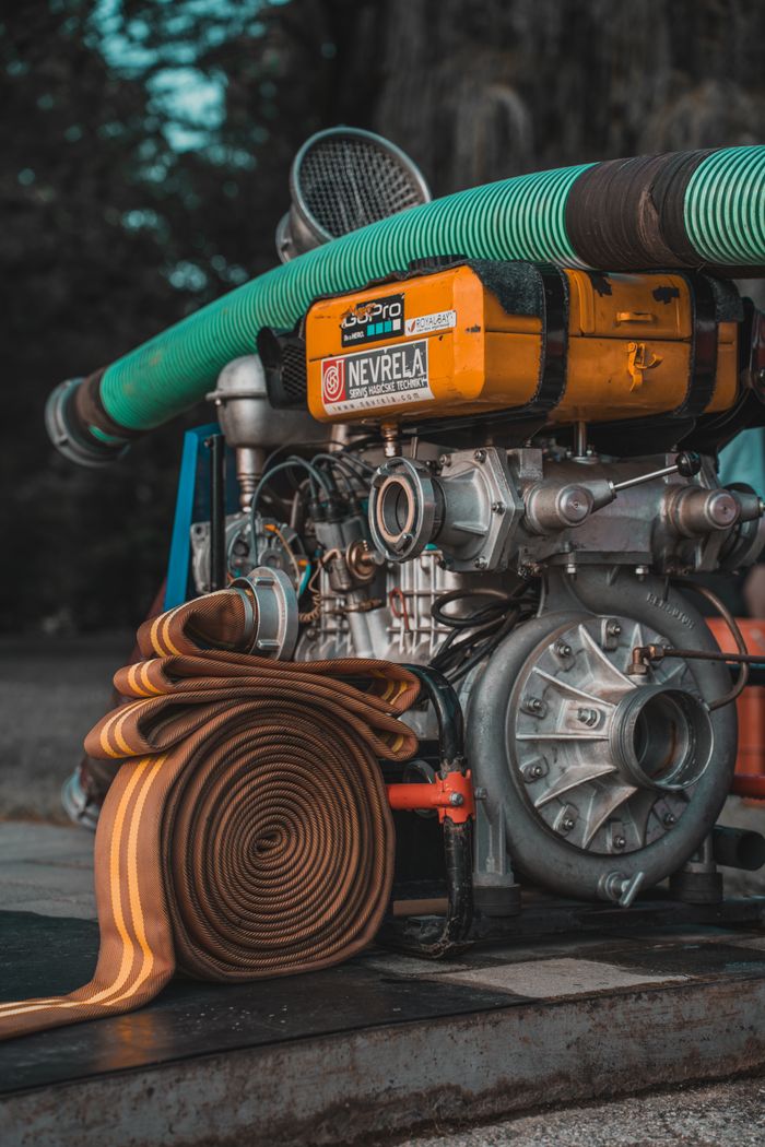 Detailed view of industrial pump with coiled hose, ideal for water and utility projects.